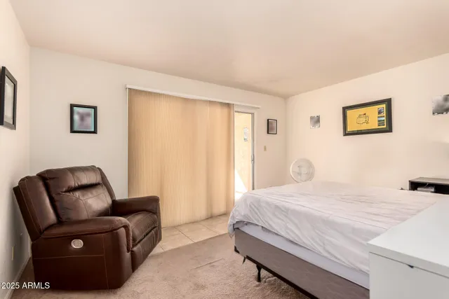 a bedroom with a bed and a couch