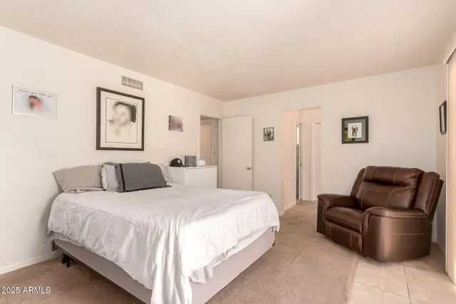 a bedroom with a bed and couch