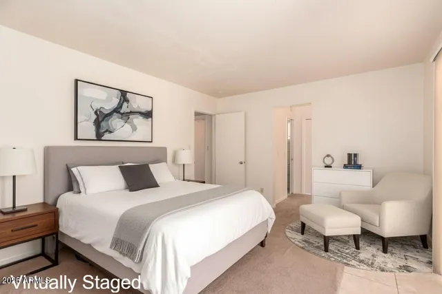 a spacious bedroom with a bed and a couch