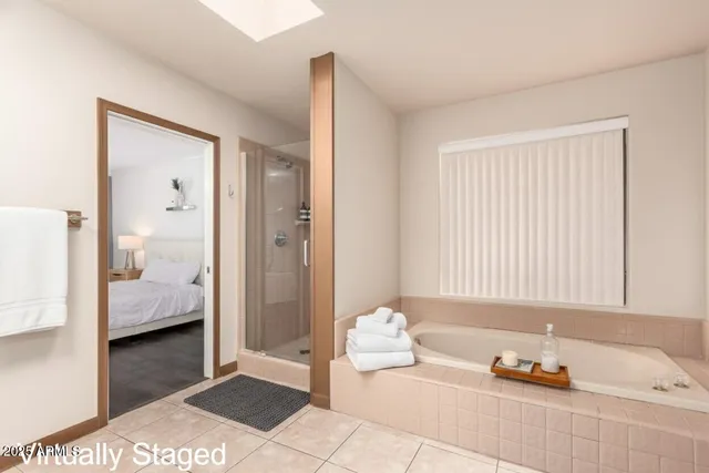 a bathroom with a tub shower and two sink