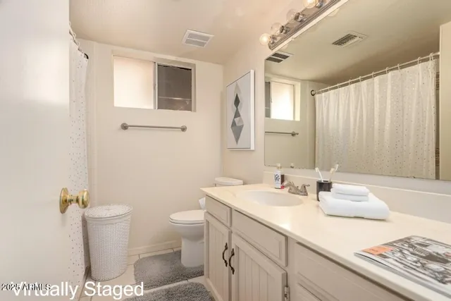 a bedroom with furniture and a fan