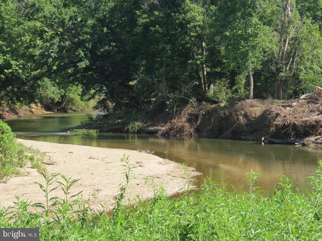 8780 Old Stillhouse Road Rixeyville, VA 22737 - Photo 25 of 28 a view of a lake in between large trees