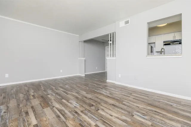 a view of a room with wooden floor and closet