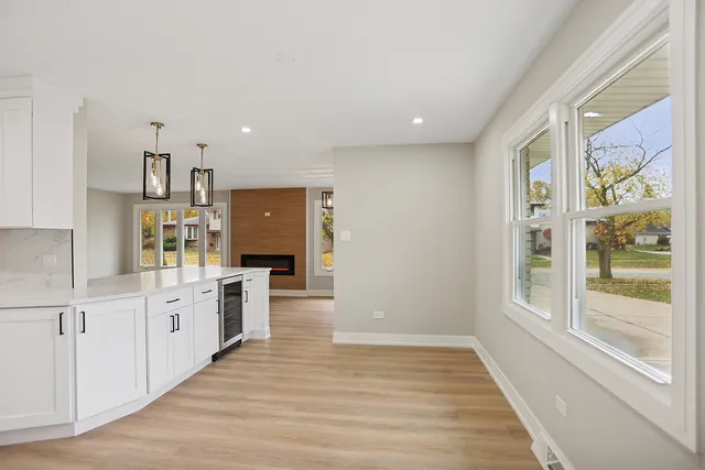 a large kitchen with a lot of counter space and wooden floor