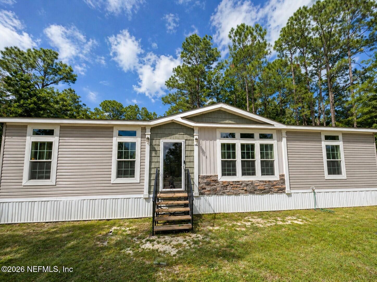 124 Jack Road Palatka, FL 32177 - Photo 18 of 18 a front view of a house with a garden