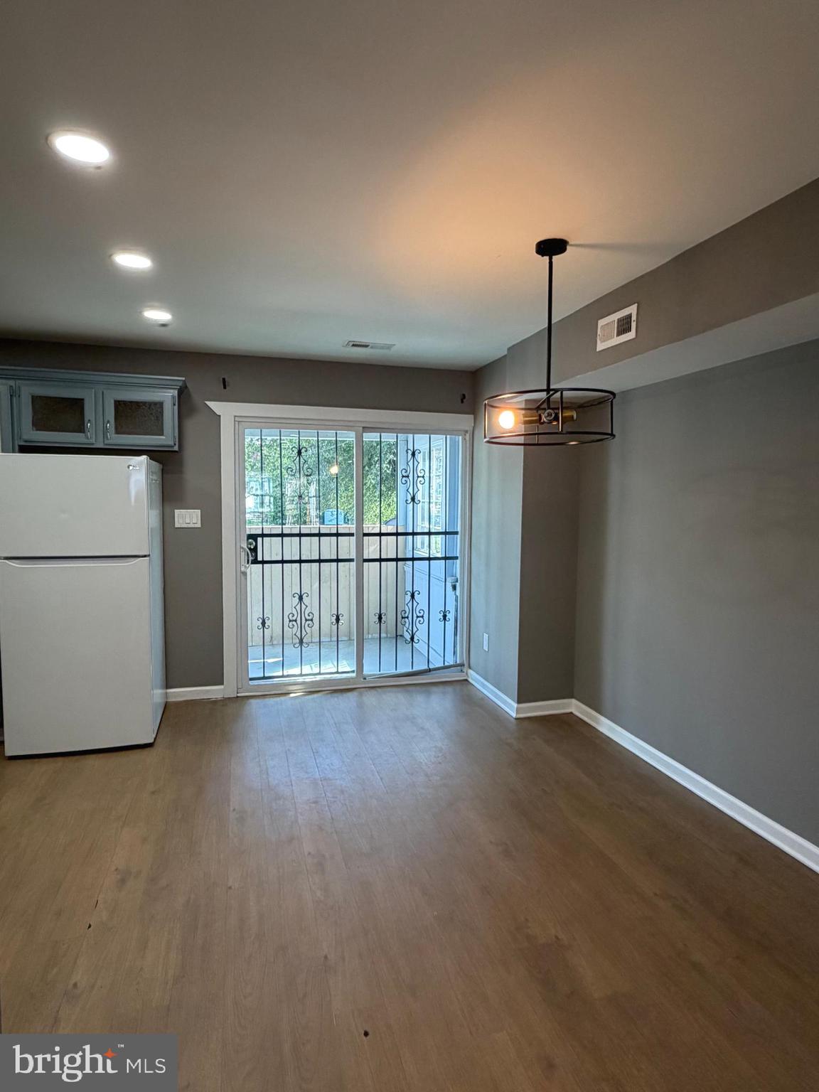 1353 Cambria Street Baltimore, MD 21225 - Photo 6 of 23 a view of an empty room with a window