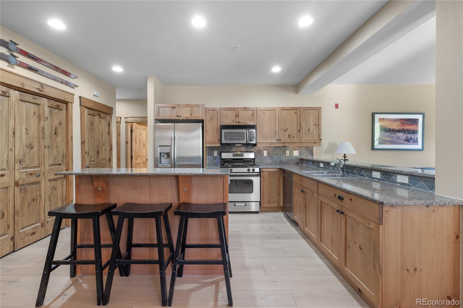 14 Arabella Drive, Unit 6516 Dillon, CO 80435 - Photo 11 of 39 a kitchen with stainless steel appliances granite countertop a table chairs sink and cabinets