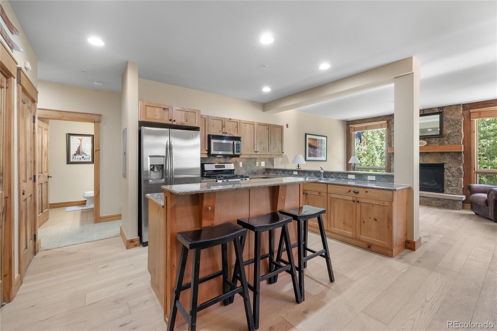 14 Arabella Drive, Unit 6516 Dillon, CO 80435 - Photo 8 of 39 a kitchen with refrigerator a sink and chairs