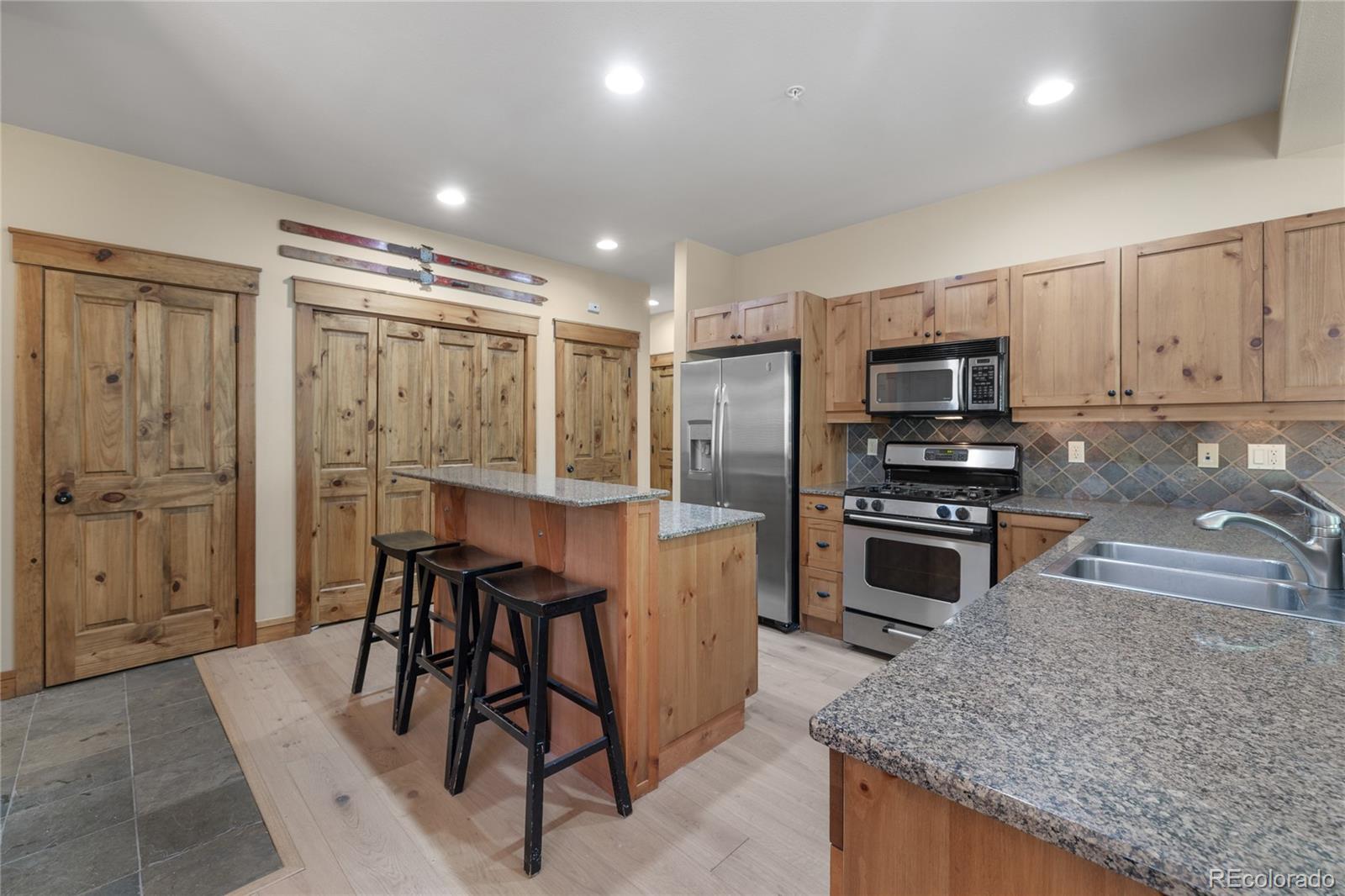 14 Arabella Drive, Unit 6516 Dillon, CO 80435 - Photo 10 of 39 a kitchen with stainless steel appliances granite countertop a stove top oven a sink refrigerator and cabinets