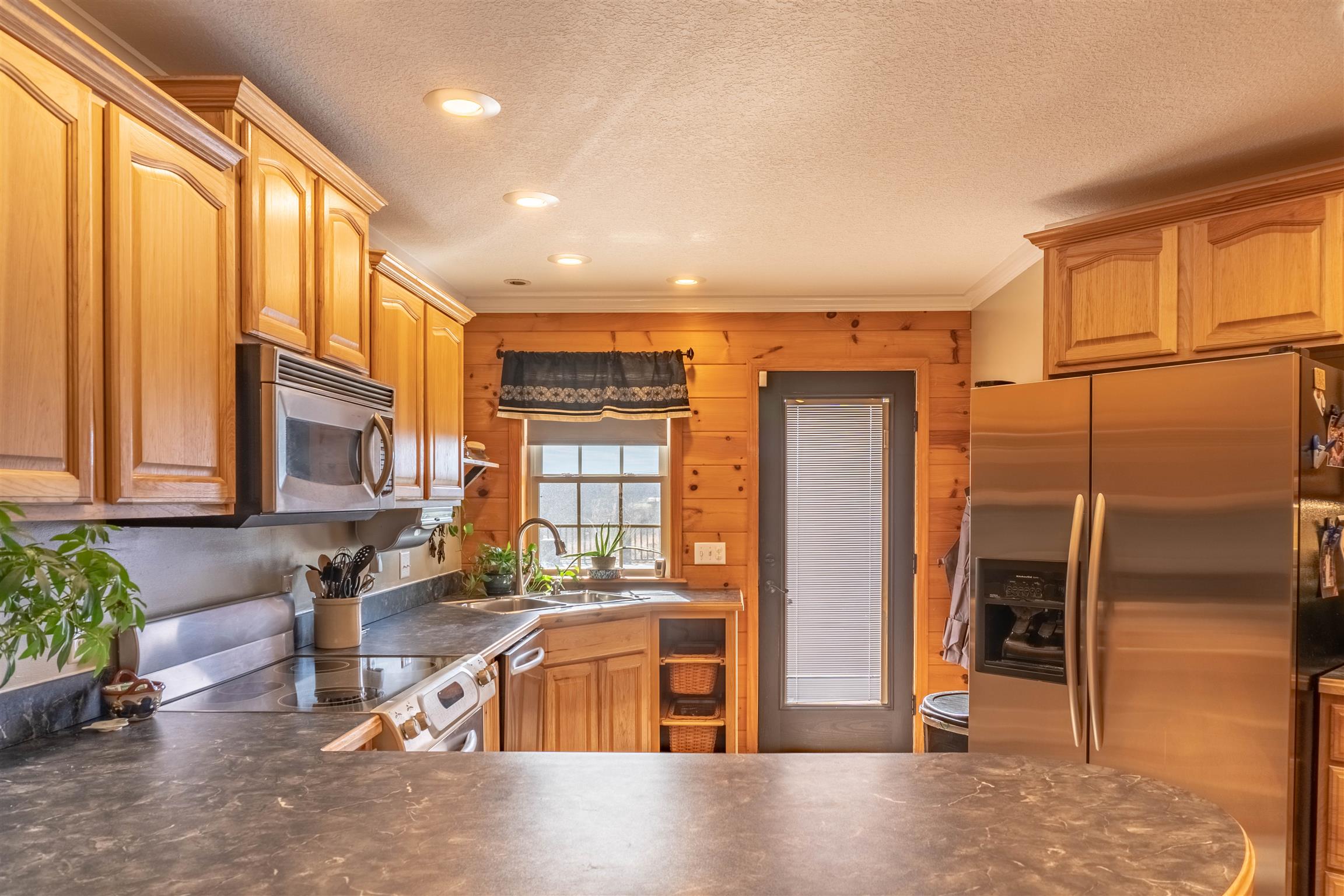 2141 Cunningham Road Cookeville, TN 38506 - Photo 8 of 30 Tons of space in the kitchen with stainless steel Kitchen-aid appliances. Door opens to the pool and extra large deck out back for easy indoor/outdoor entertaining!
