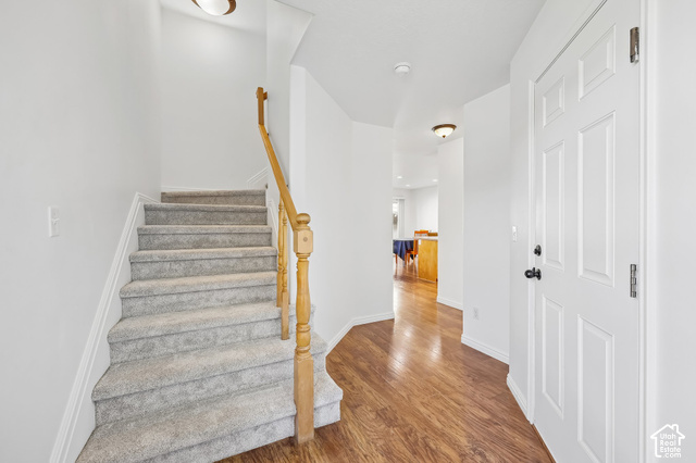 3863 East Cascade Road, Unit 3 Eagle Mountain, UT 84005 - Photo 5 of 37 Hardwood-finish flooring, carpeted staircase, light wood-tone handrail, recessed lighting, and panel door