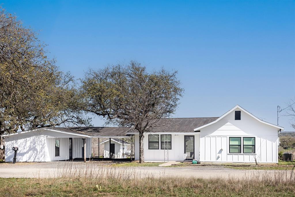 a view of house with a yard
