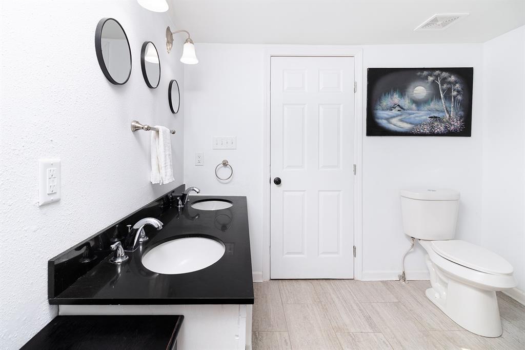 1815 South Oak Street Brady, TX 76825 - Photo 13 of 34 a bathroom with a sink and a mirror