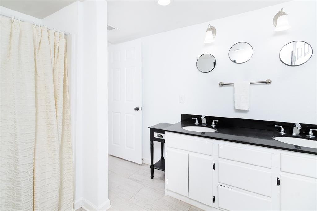 1815 South Oak Street Brady, TX 76825 - Photo 14 of 34 a bath room with a sink and a mirror