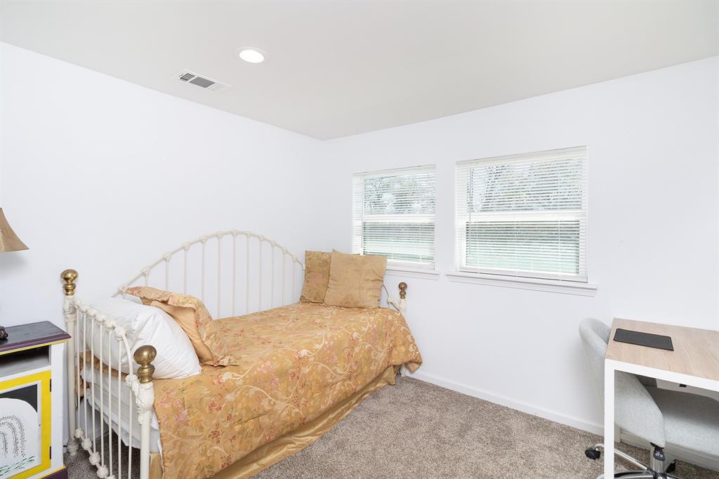 1815 South Oak Street Brady, TX 76825 - Photo 17 of 34 a bed sitting in a bedroom next to a window
