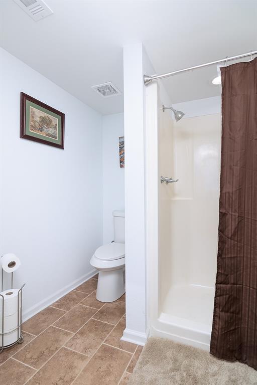 1815 South Oak Street Brady, TX 76825 - Photo 18 of 34 a bathroom with a toilet and a shower