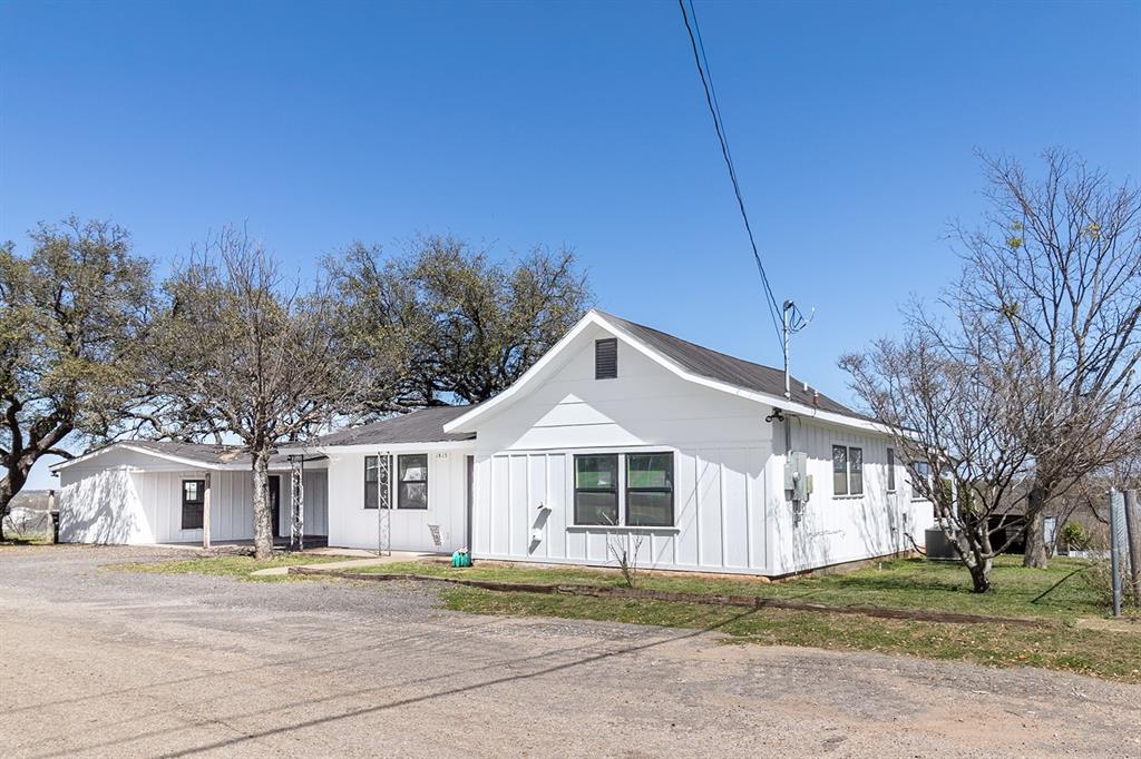 1815 South Oak Street Brady, TX 76825 - Photo 2 of 34 a front view of a house with a yard