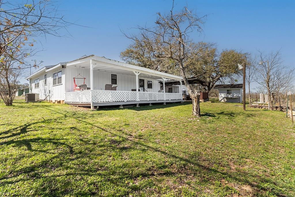 1815 South Oak Street Brady, TX 76825 - Photo 26 of 34 a front view of a house with a yard