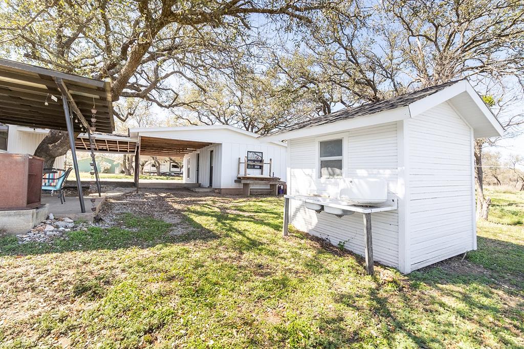 1815 South Oak Street Brady, TX 76825 - Photo 28 of 34 a view of a house with backyard and sitting area