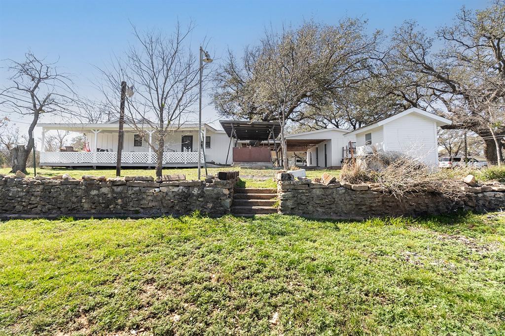 1815 South Oak Street Brady, TX 76825 - Photo 29 of 34 a view of a house with a big yard and large trees