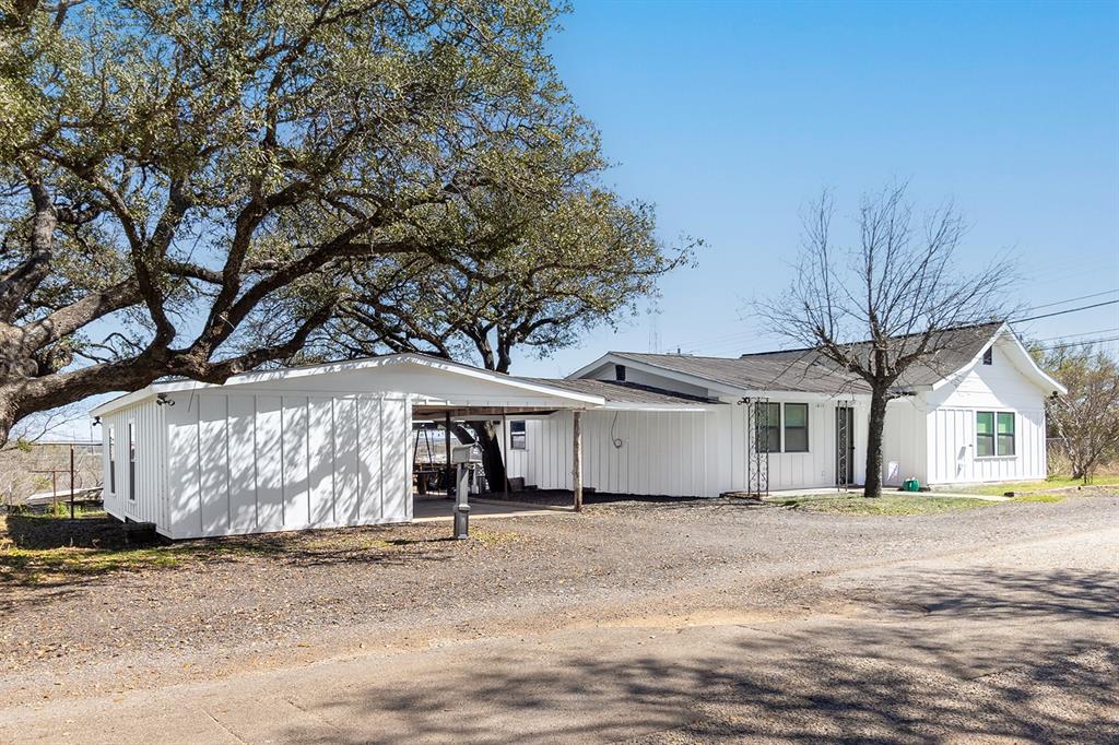 1815 South Oak Street Brady, TX 76825 - Photo 33 of 34 a view of a white house with a large tree in front of it