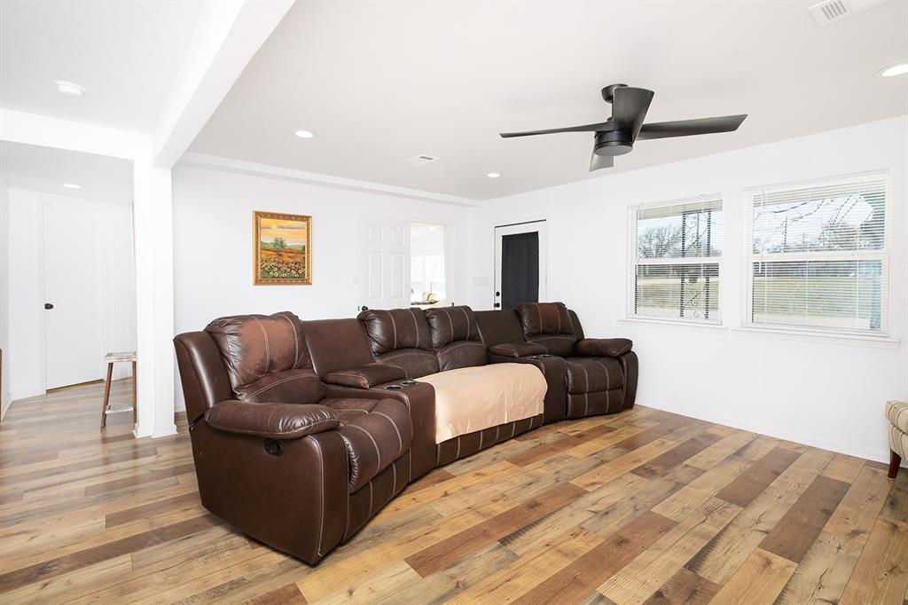 1815 South Oak Street Brady, TX 76825 - Photo 8 of 34 a living room with couches painting on the wall and a window