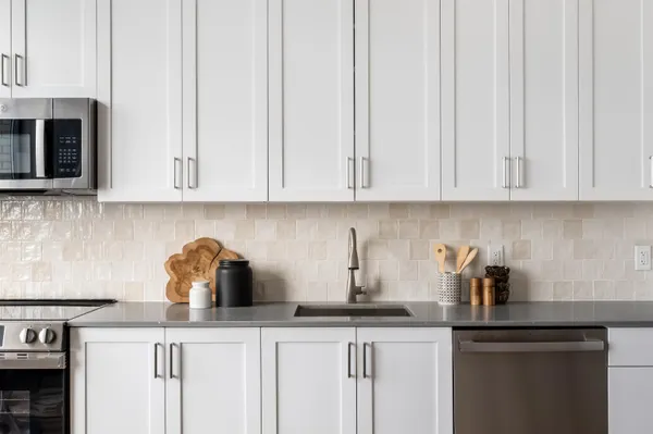 a kitchen with appliances a sink and cabinets
