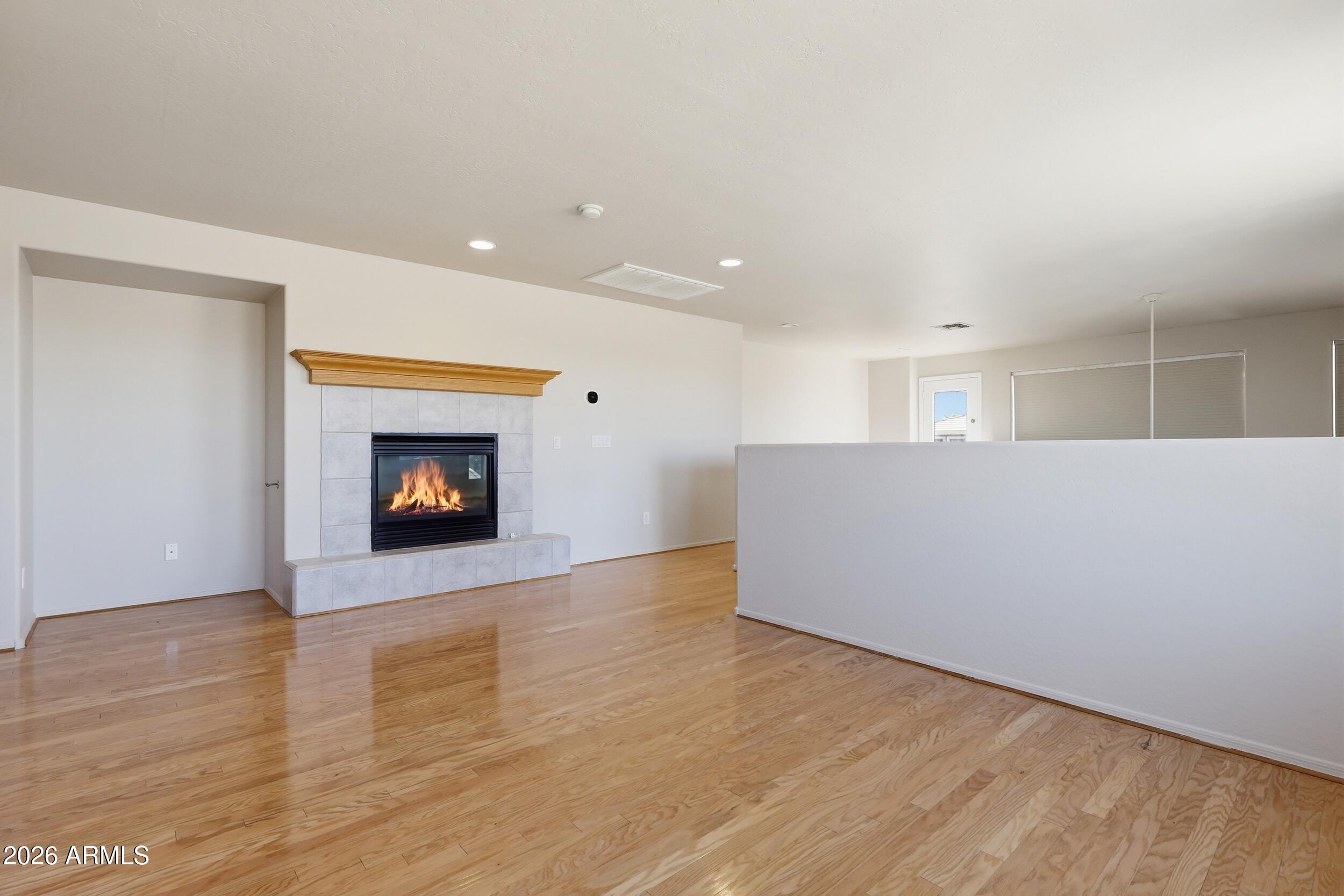 4122 South Clancy Mesa, AZ 85212 - Photo 9 of 70 a view of an empty room with wooden floor fireplace and a window