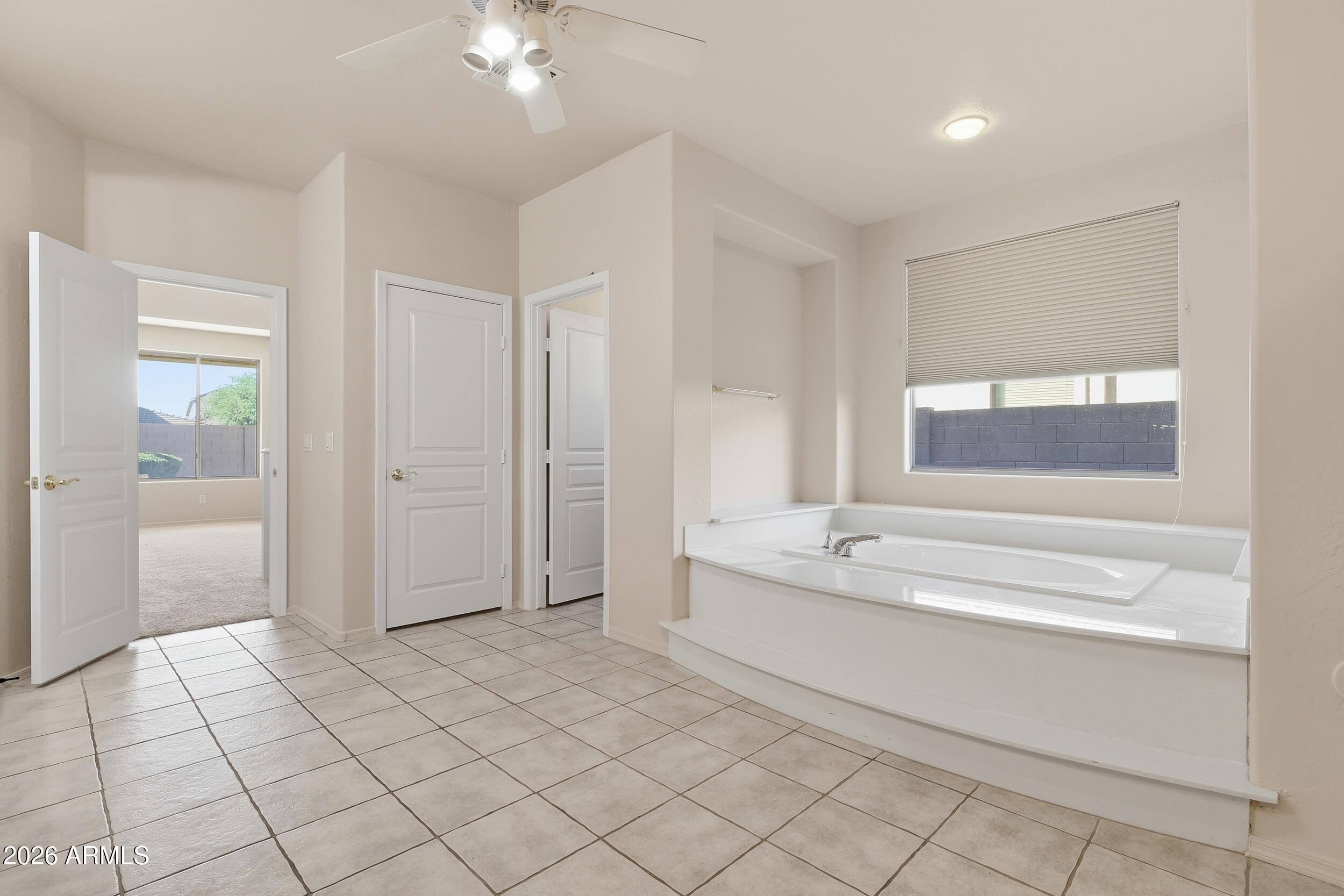 4122 South Clancy Mesa, AZ 85212 - Photo 33 of 70 a spacious bathroom with a granite countertop sink a mirror and a bathtub