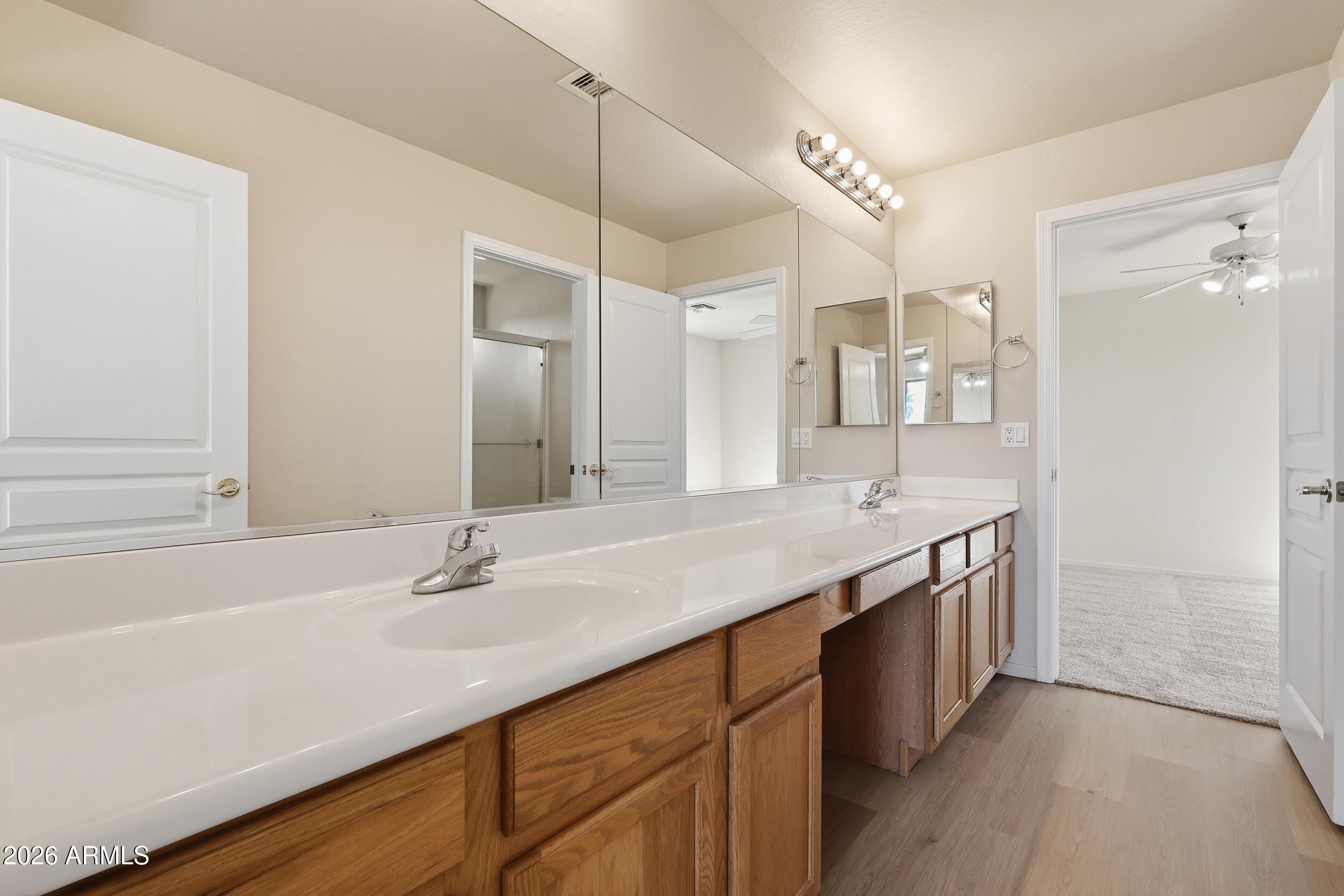 4122 South Clancy Mesa, AZ 85212 - Photo 45 of 70 a bathroom with a granite countertop sink and a mirror