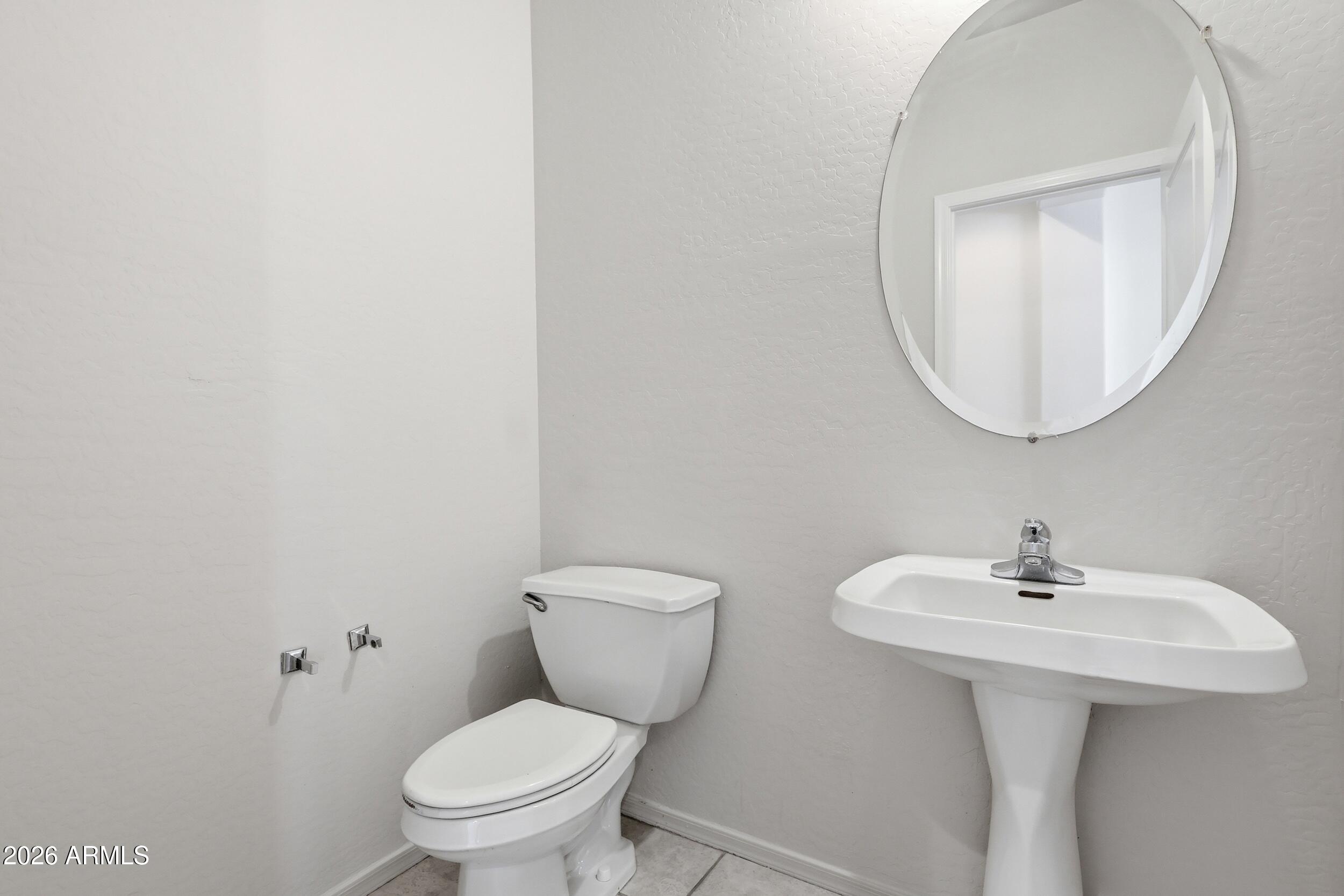 4122 South Clancy Mesa, AZ 85212 - Photo 55 of 70 a bathroom with a toilet a sink and a mirror