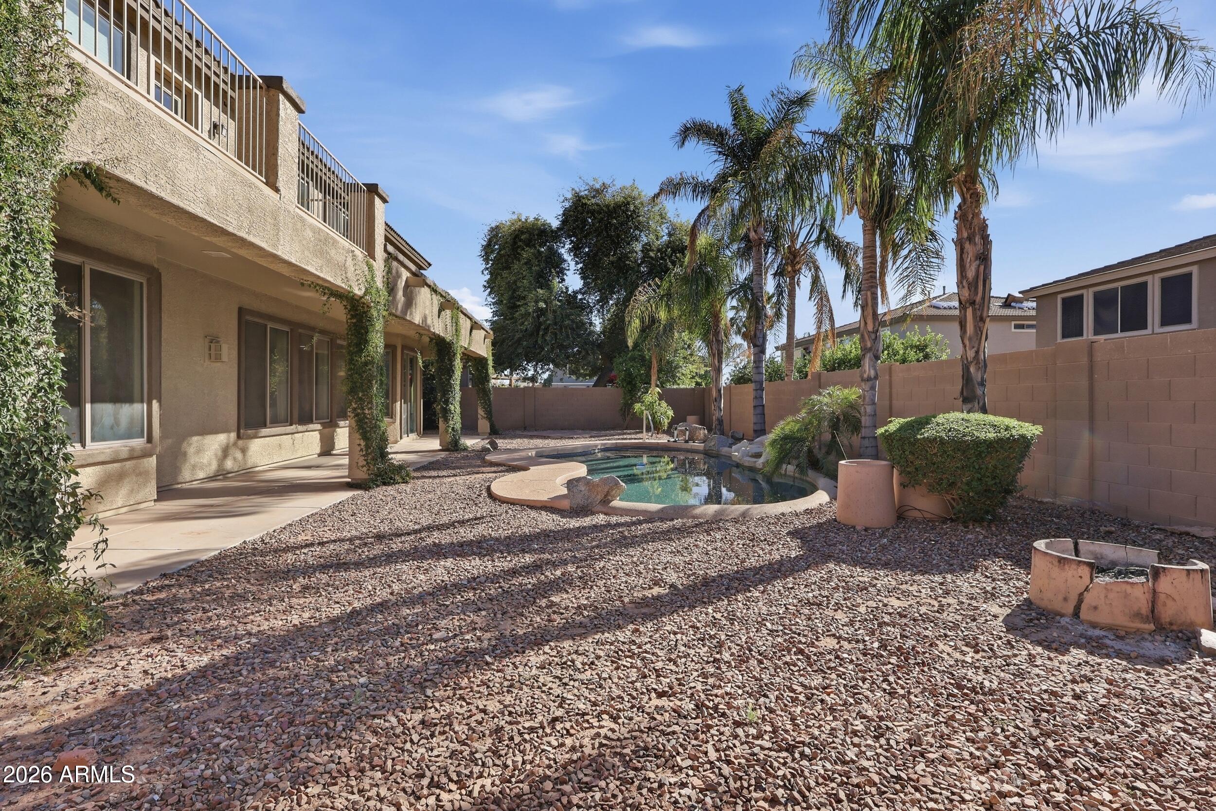 4122 South Clancy Mesa, AZ 85212 - Photo 60 of 70 a view of a backyard with potted plants and a large tree