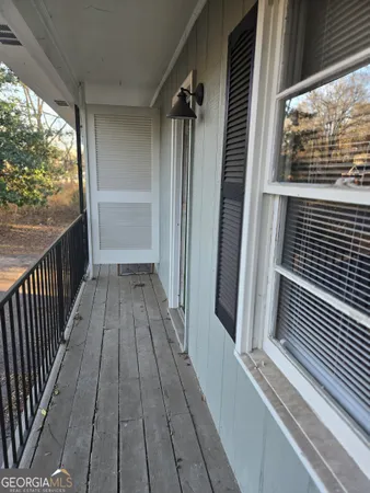 a view of balcony with wooden floor
