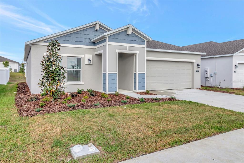 275 Puma Loop Groveland, FL 34736 - Photo 2 of 41 a front view of a house with garden