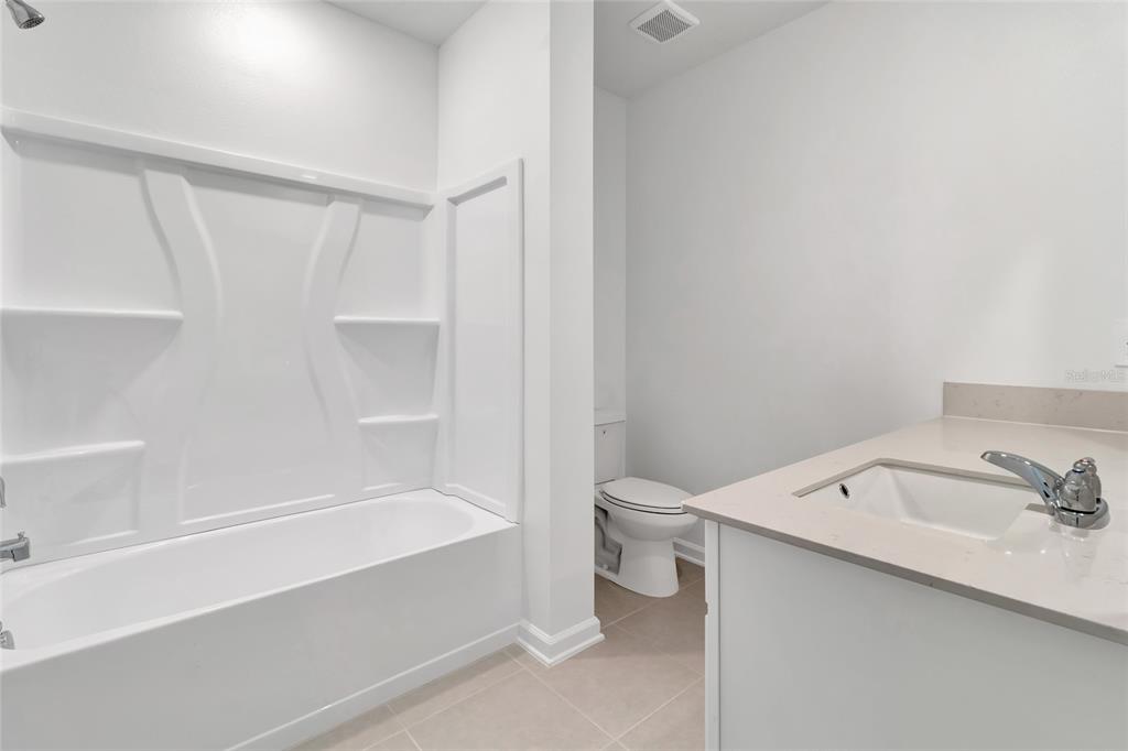 275 Puma Loop Groveland, FL 34736 - Photo 24 of 41 a bathroom with a sink a toilet and shower