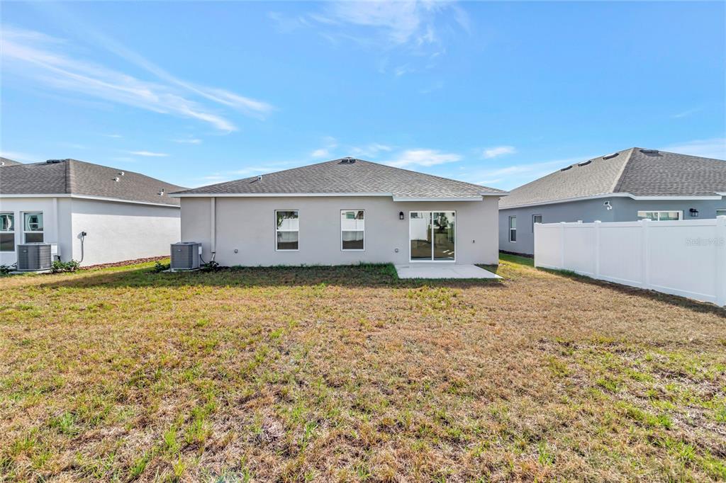 275 Puma Loop Groveland, FL 34736 - Photo 30 of 41 a view of a house with a backyard