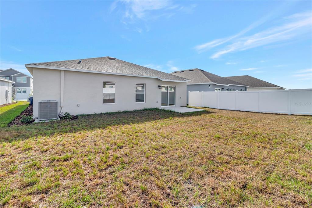 275 Puma Loop Groveland, FL 34736 - Photo 32 of 41 a view of a house with a yard