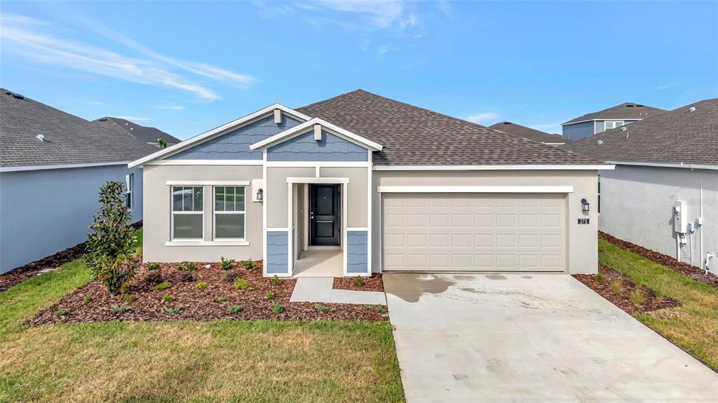 275 Puma Loop Groveland, FL 34736 - Photo 40 of 41 a front view of a house with a yard and garage