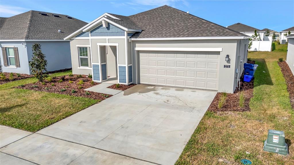 275 Puma Loop Groveland, FL 34736 - Photo 41 of 41 a front view of a house with a yard and garage