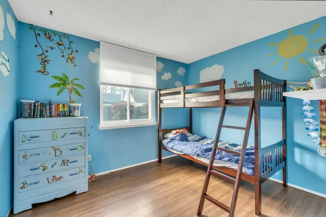 a bedroom with bunk bed and a window