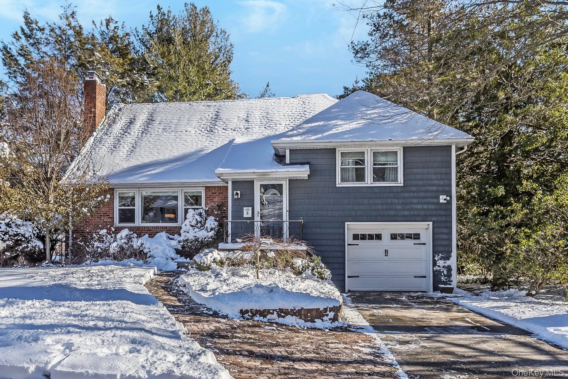 16 Cliff Way Port Washington, NY 11050 - Photo 1 of 1 Tri-level home with a chimney, a garage, and driveway