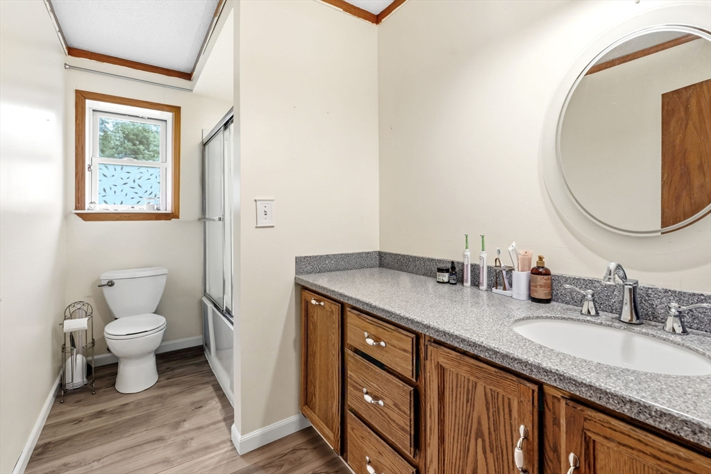 22 Lyon Hill Road Chester, MA 01011 - Photo 28 of 38 a bathroom with a granite countertop toilet sink and mirror