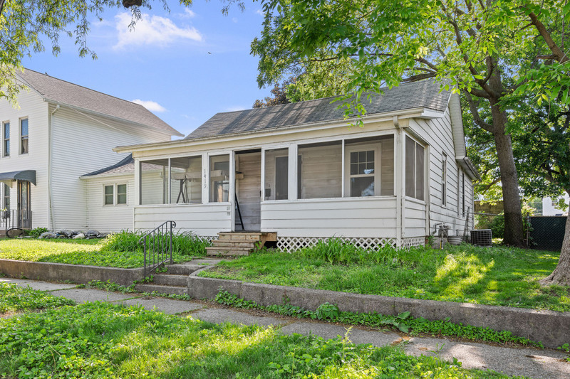 1419 17th Street Moline, IL 61265 - Photo 3 of 28 a front view of a house with a yard