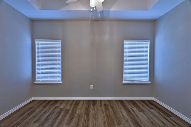 a view of an empty room with wooden floor