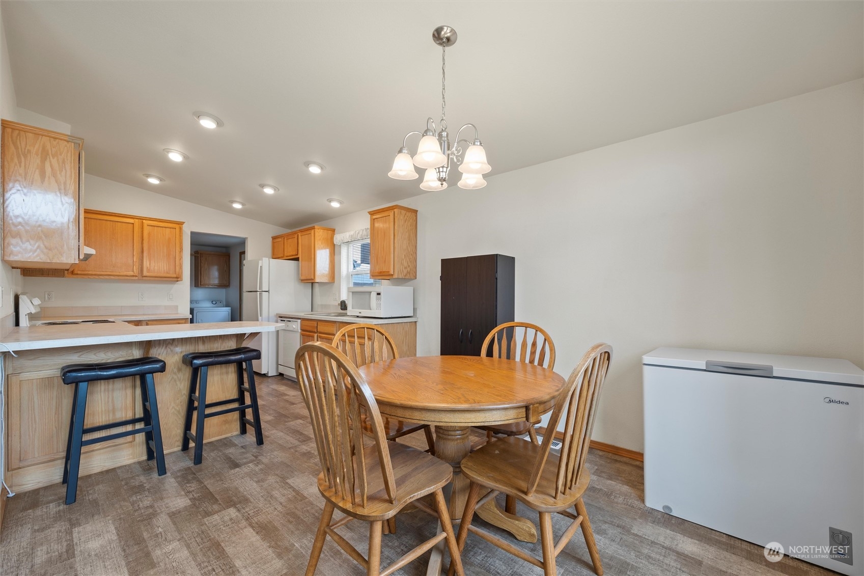 85 Second Street Touchet, WA 99360 - Photo 8 of 28 a dining room with furniture a chandelier and wooden floor