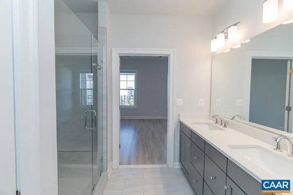 a bathroom with a sink vanity and a mirror