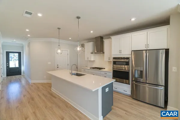a kitchen with a sink stainless steel appliances and refrigerator