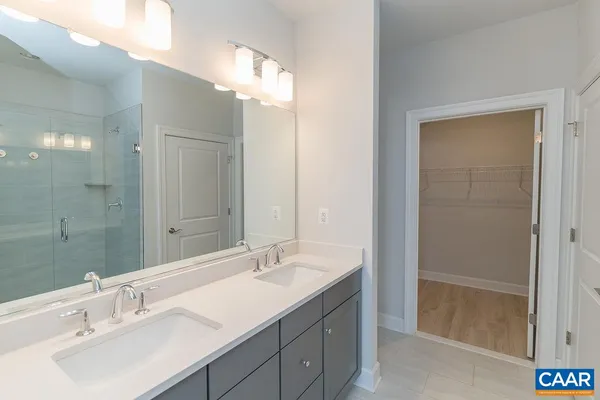 a bathroom with a double vanity sink and a mirror