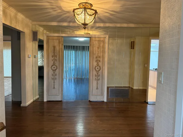 a view of a hallway with wooden floor