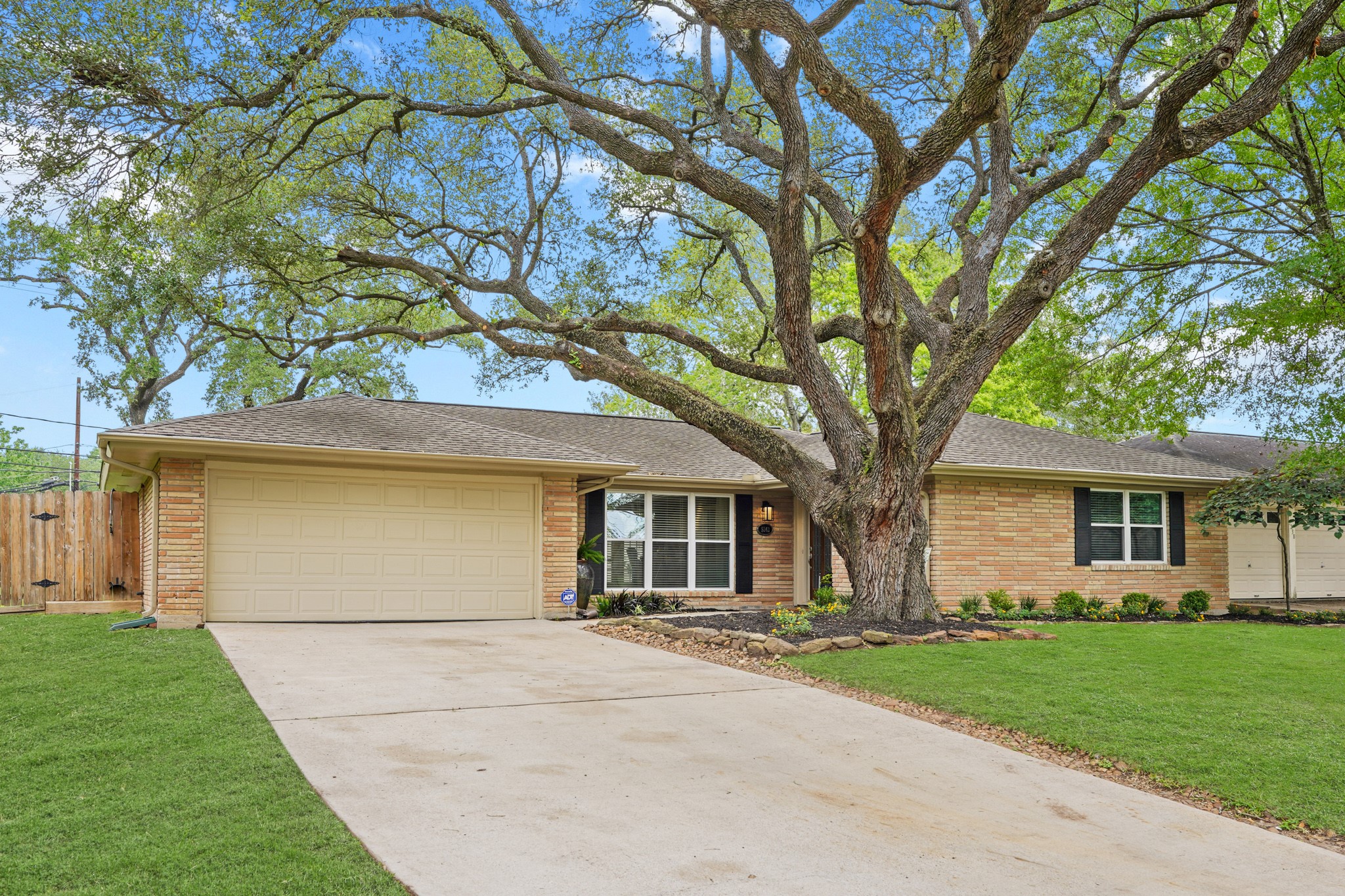 5242 Sanford Road Houston, TX 77035 - Photo 1 of 34 Charming single-story brick home with a two-car garage and updated driveway. Large, mature tree in the front yard, providing shade and beauty. Newly landscaped and pretty curb appeal.